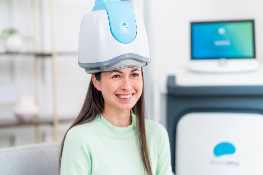 Woman receiving treatment for deep transcranial magnetic stimulation