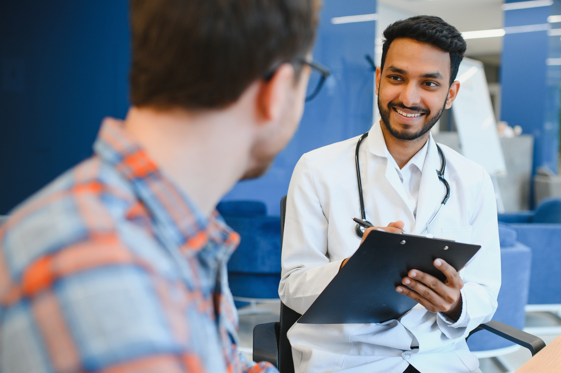 smiling doctor facing a patient