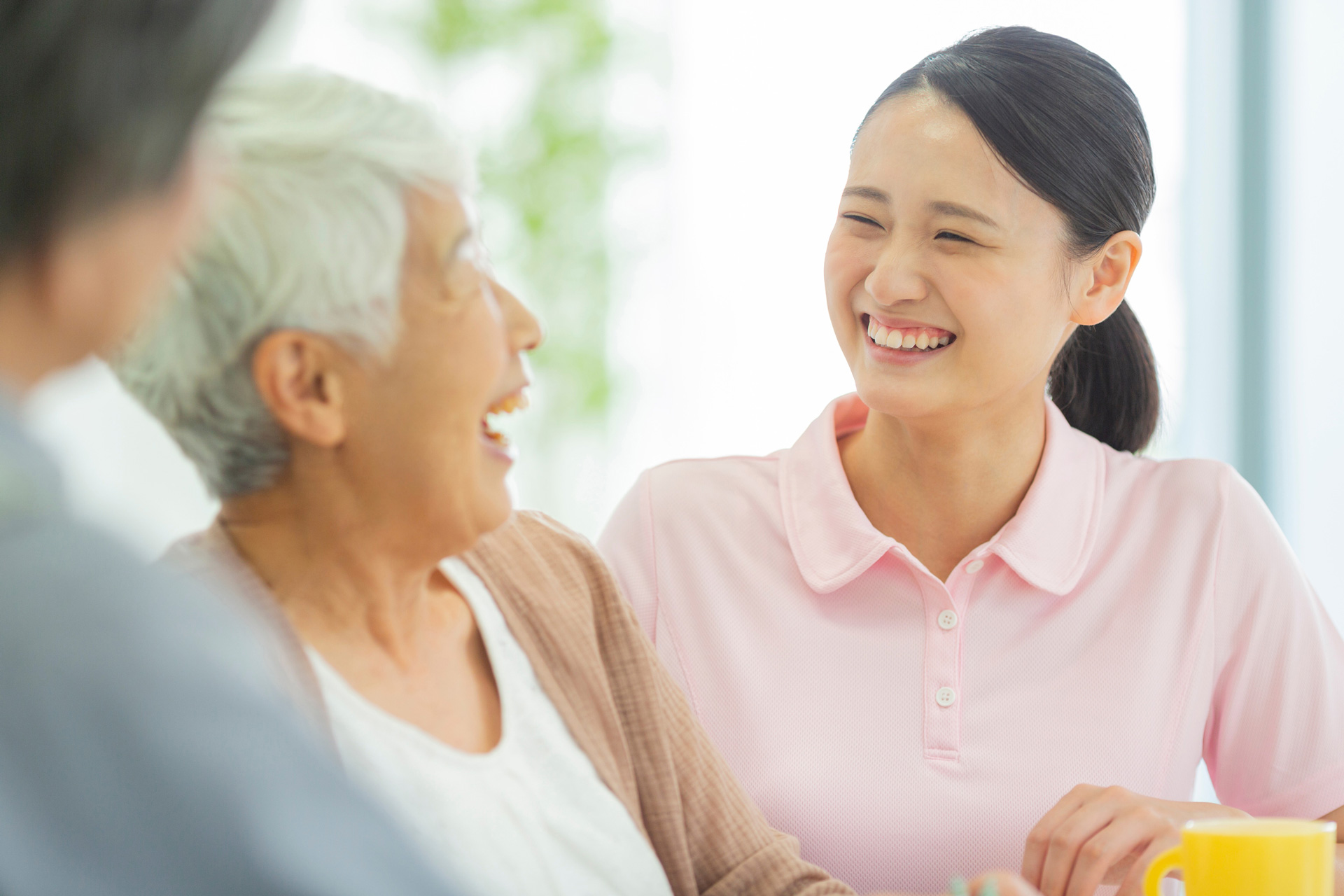 young woman smiling at a smiling older woman