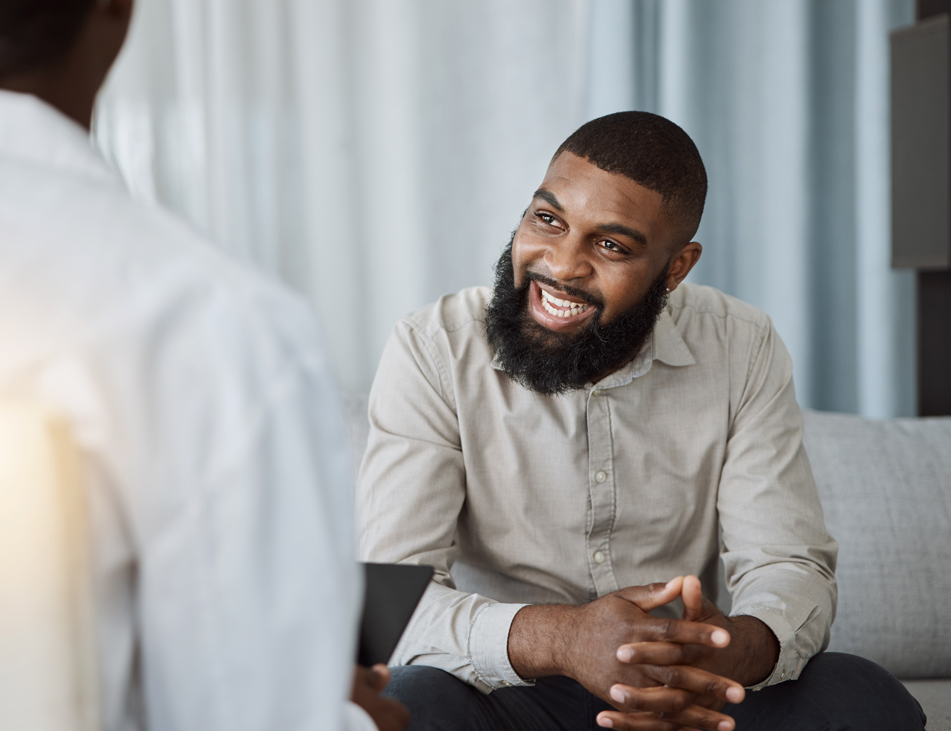 smiling man sitting on couch