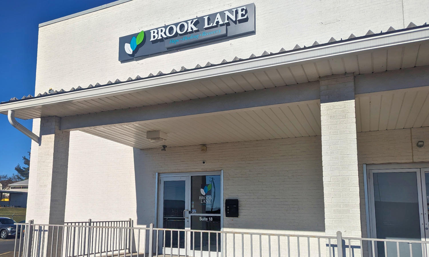 Brook Lane building with Brook Lane sign.